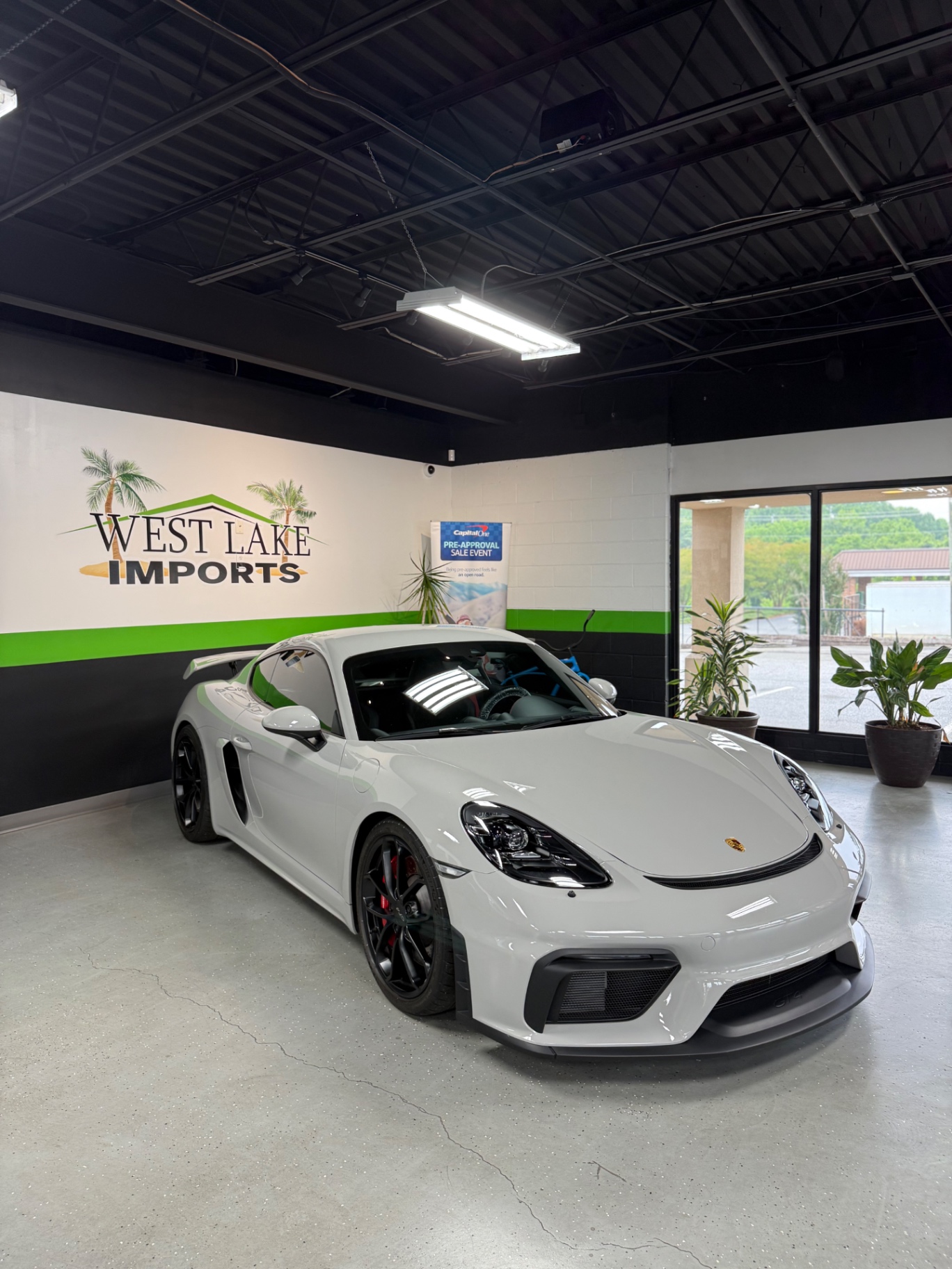 White Porsche sports car detailed inside a showroom
