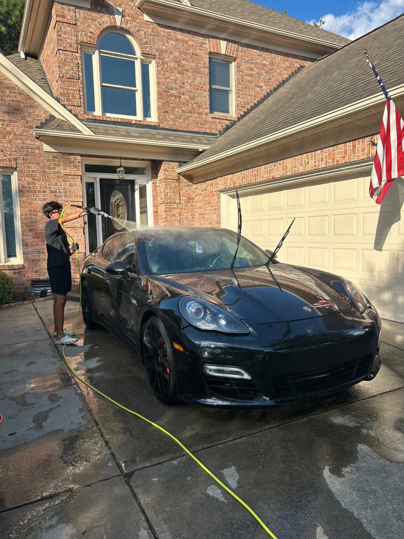 Porsche Panamera receiving an exterior wash at a home driveway