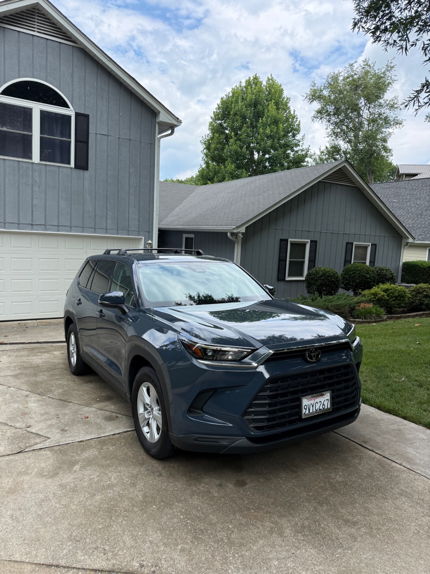 Blue Ram truck with freshly detailed exterior parked in a driveway