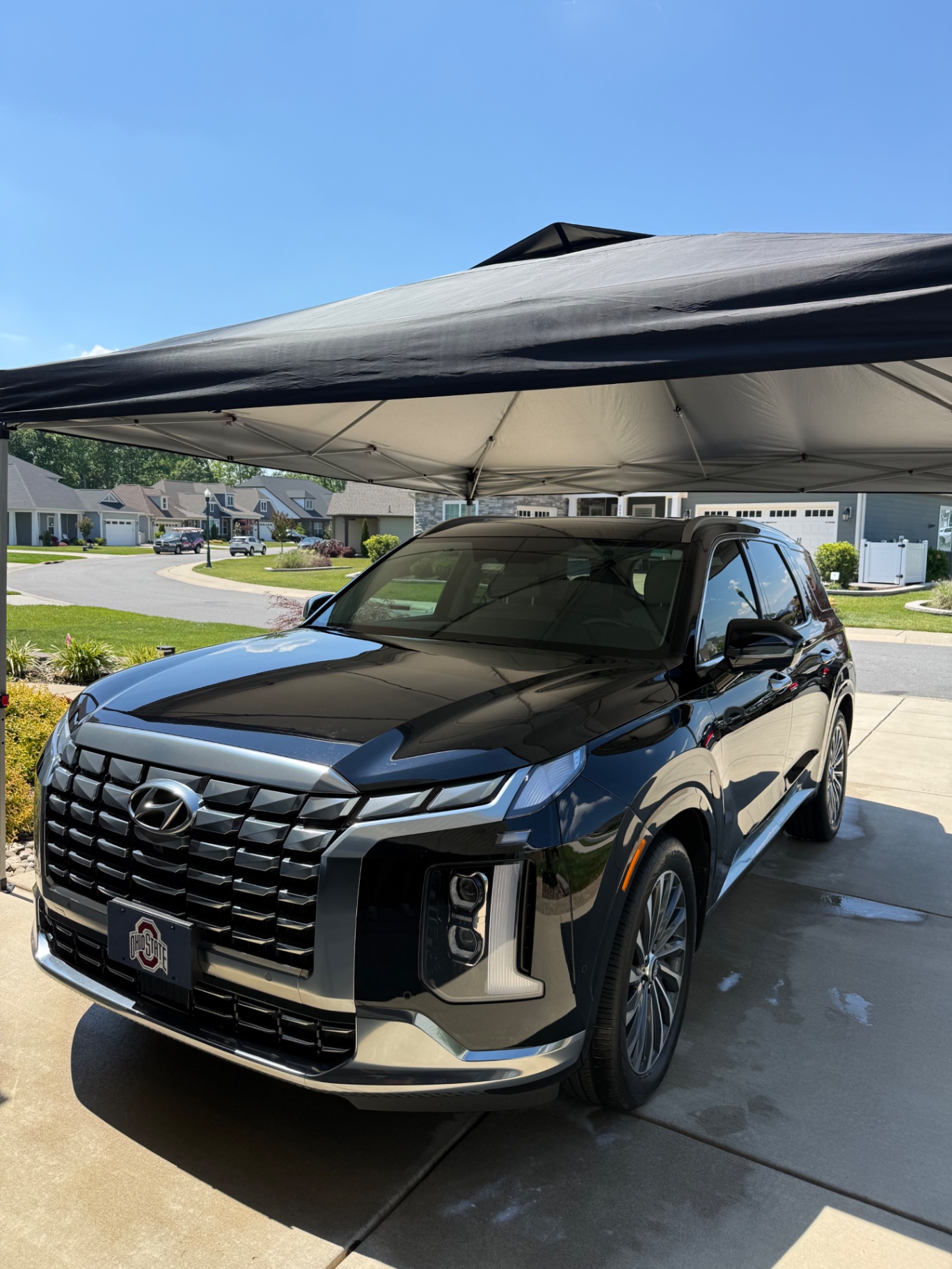Black Hyundai SUV under a mobile detailing canopy