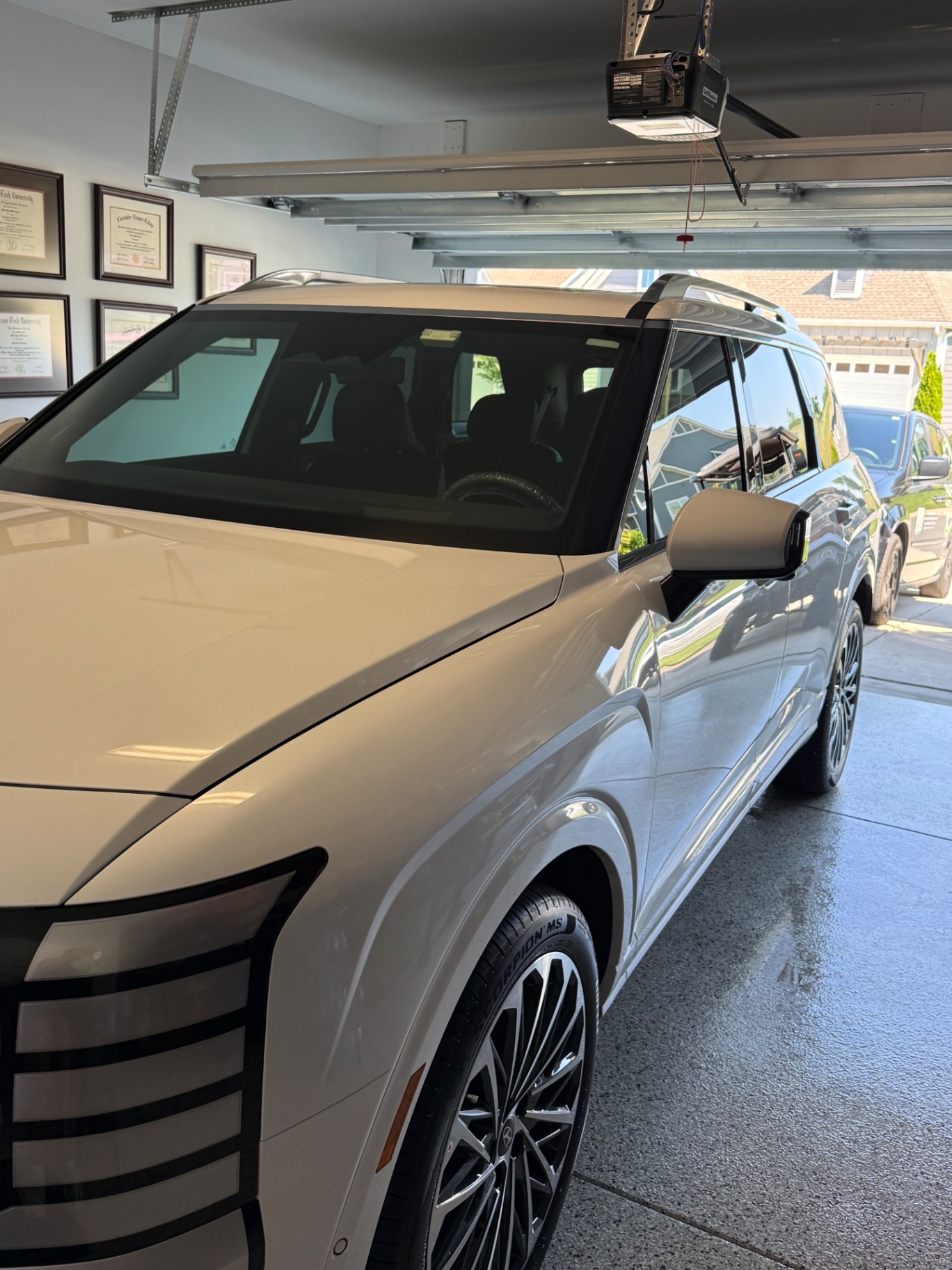 White luxury SUV with clean glossy exterior in a garage